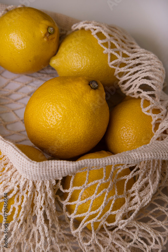 Yellow Lemons in Mesh Bag – Minimal Lifestyle Flat Lay on White Background