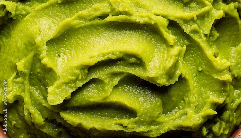 Fototapeta premium Close-up of a mashed avocado texture background