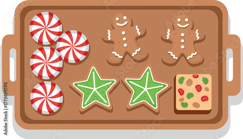 Assortment of Christmas cookies and candies on a baking tray