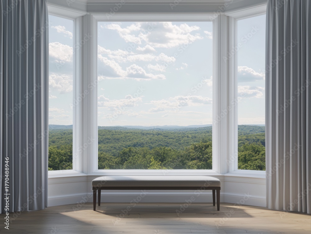 Fototapeta premium A bright, modern interior features large windows with a scenic view of lush greenery and a cloudy sky, creating a serene atmosphere.