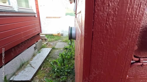 4K close-up video showing a person plugging a device into a wall power socket indoors.