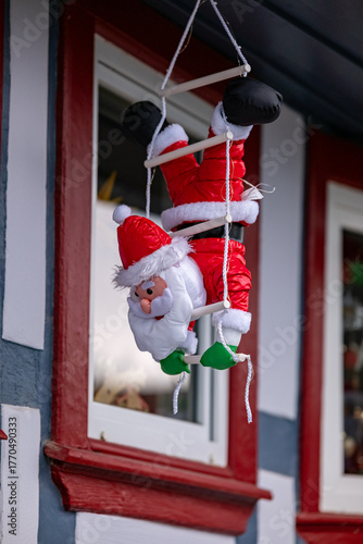 Christmas decor. Figure of decorative Santa Claus on the facade of the house.