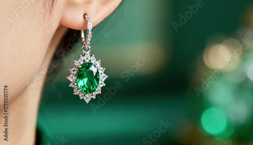 Luxurious emerald jewel earring creating beautiful aesthetic. An elegant woman wears fine jewelry for special occasion
