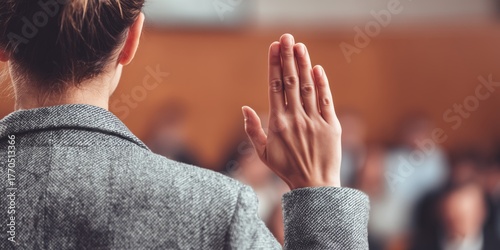 Female witness taking an oath in a courtroom with his right hand raised, symbolizing honesty, integrity, and responsibility in the judicial process.