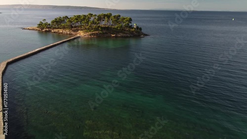 small uninhabited island in the Adriatic Sea, Croatia, shot by a drone, early autumn, late morning, the camera is stationary