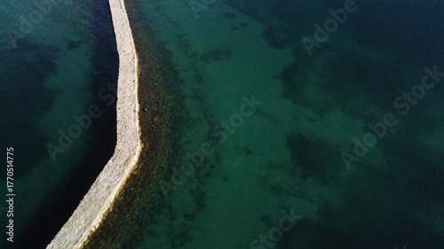 water polo field by the sea, by the concrete jetty, sunny day, summer, calm sea, view from a drone