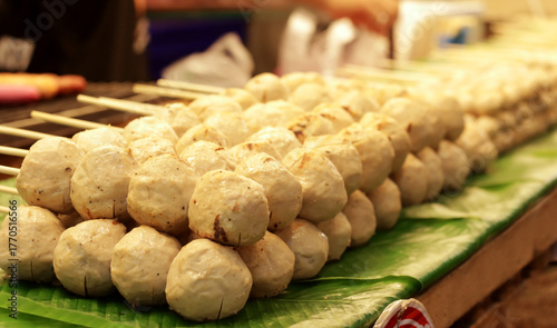 Fotografie White round meatballs are sold in the night market.