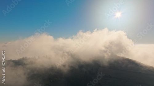 A Serene Mountain Landscape Featuring Fog Enhanced by Sunlight