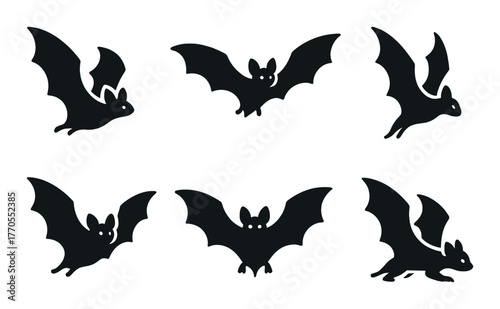 Silhouettes of bats against a dark background