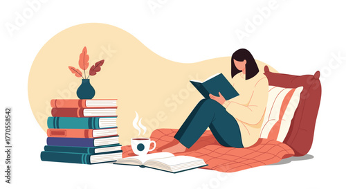 A woman sits comfortably surrounded by books and a warm drink, enjoying a moment of quiet reading indoors.
