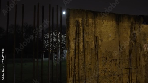 Berlin Wall Historical Monument, Pathway glow, Wall illumination. Path and area around Berlin Wall Memorial softly lit by dim streetlights at night.