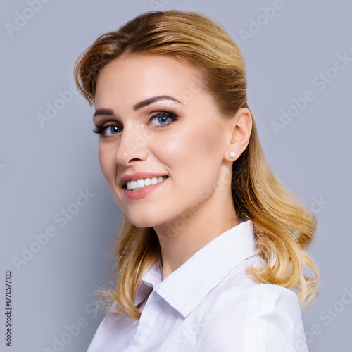 Portrait of happy smile young businesswoman, corporate cute business woman wear white shirt, isolated against grey gray background. Square image