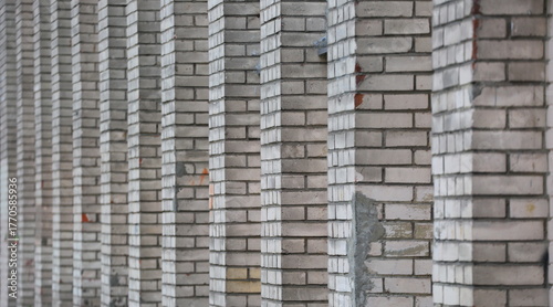 A white brick wall with repeating protrusions
