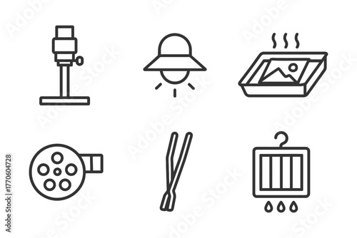 Vintage photography icons and equipment: enlarger, lamp, development tray, film reel, tongs, darkroom hanger.