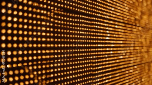 A close-up view of golden lights arranged in a grid, creating a dazzling array with a focus