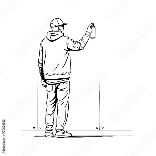 Young graffiti artist standing in front of a wall holding a spray can, preparing to paint urban street art.