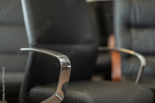 Close up detail of office arm chairs, nobody is visible.