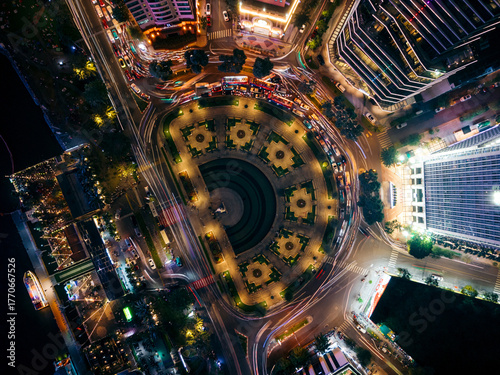 Aerial view of a brightly lit circular city intersection at night with bustling traffic. Ho Chi Minh City, Vietnam