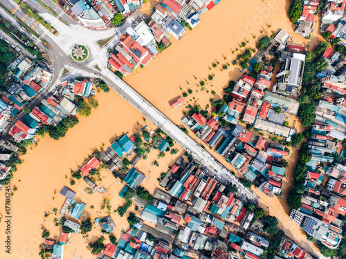 Aerial view of a flooded urban area with muddy river and colorful rooftops. Cao Bang city, Cao Bang, Vietnam
