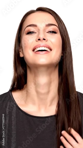 Smiling woman with dark hair in a black shirt against a white background