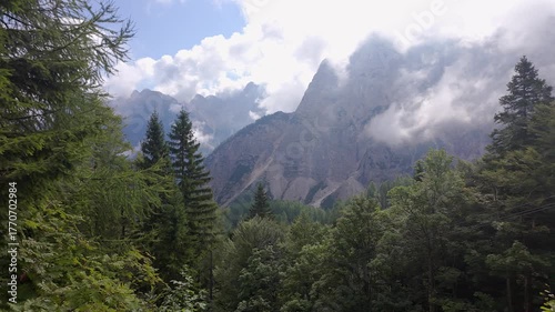 Stunning mountain scenery with the sun rising through the clouds in the Golicica Mountains, Slovenia.
