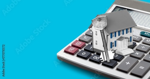 House model on office calculator. Mortgage loan