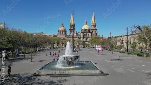 Stationary shot of the main fountain in Plaza Tapatia, Guadalajara, with the iconic cathedral behind