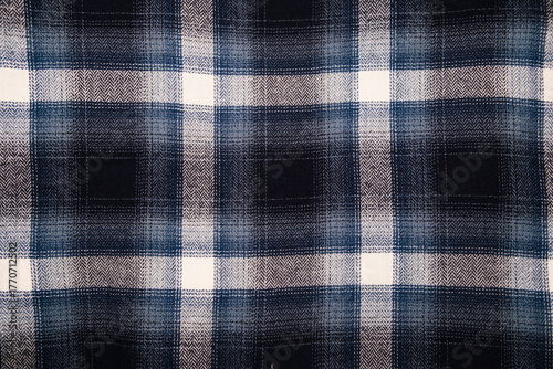 A rugged and soft flannel plaid fabric in dark tones, featuring a large, classic check pattern in navy blue, black, gray, and off-white. Perfect for grunge, lumberjack, or cozy winter fashion themes