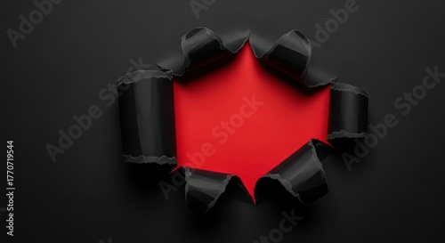 Torn black paper with bright red background: dramatic contrast and texture