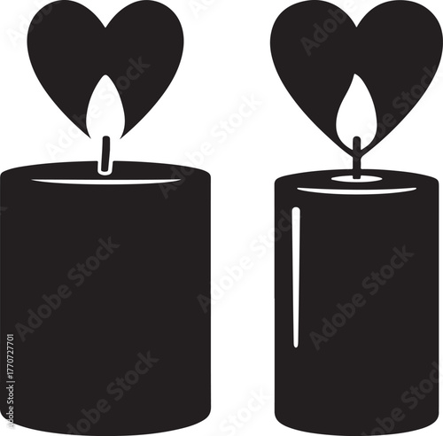 Two romantic heart shaped flame candles burning brightly silhouette