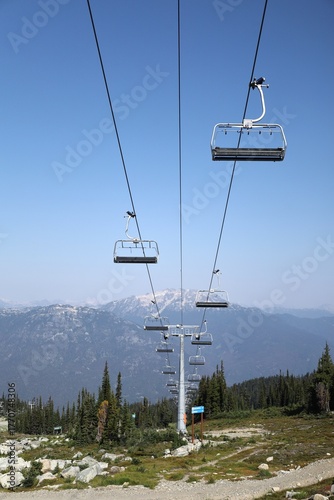 Ski chair lift in summer with mountain background