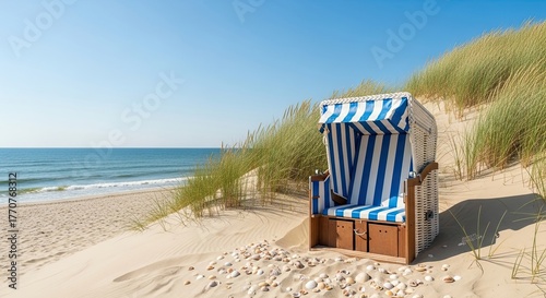 Serene beach chair awaits on sandy dunes overlooking calm ocean under clear blue sky