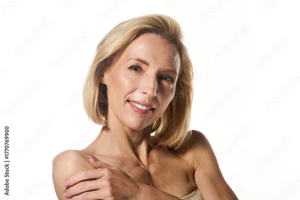 Fototapeta premium Beautiful blonde woman shares her secrets for healthy skin in a bright setting