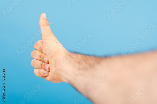 A human hand giving thumbs ...