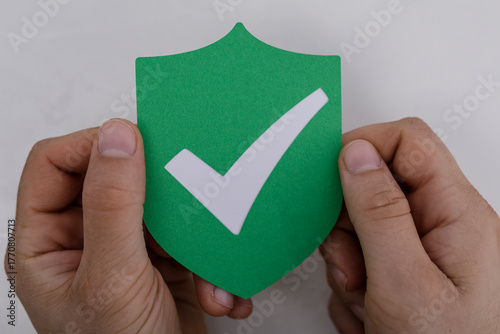 A person holding a green sh...
