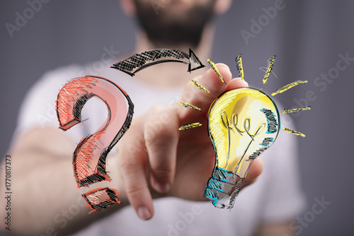 Hand pointing at lightbulb,...