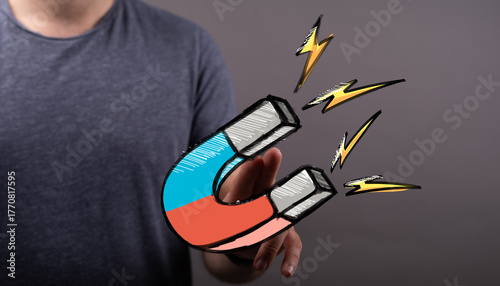 Hand holding a strong magne...