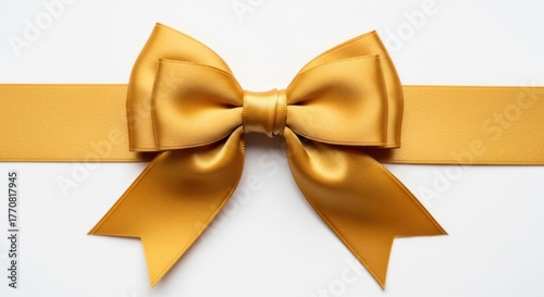 Shiny golden satin bow tied horizontally on a ribbon, against a clean white backdrop