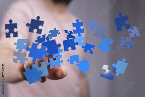 Hand holding puzzle pieces,...