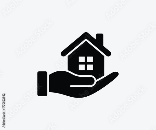 Hand holding house icon representing home ownership and real estate