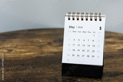 May 2026 calendar monthly page on wooden table background