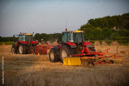 tractors are turning hay to dry and collect it