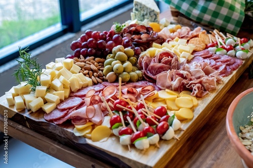 Charcuterie board with cheese, salami, eggs, fruits and grains