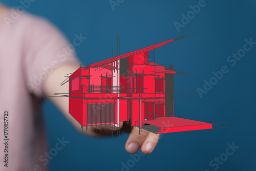 Hand holding a house bluepr...