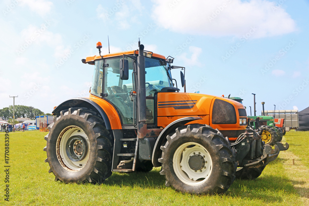 Obraz premium Vintage tractors standing in a field