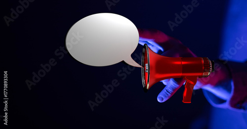 Hand holding red megaphone ...