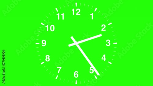 Time-lapse shot of a wall clock's hands rotating for a full 12 hours against a green screen. The clock face and hands are white.