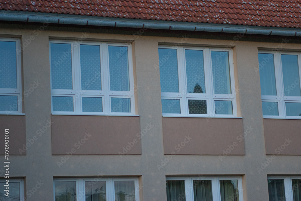 Obraz premium Modern apartment windows with patterned curtains