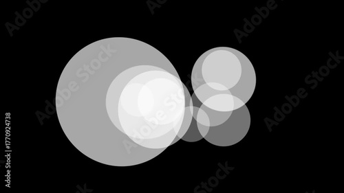 Abstract composition of overlapping translucent circles in varying shades of gray against a stark black background