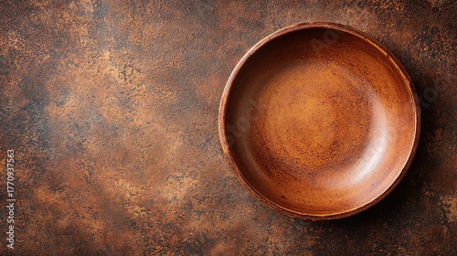 Glazed clay background rustic terracotta ceramic bowl warm copper bronze tones handcrafted pottery surface natural texture overhead view artisan backdrop design